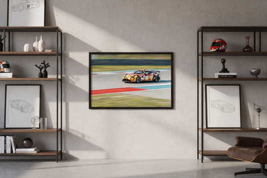 Poster of a race car on a wall between two bookshelves.